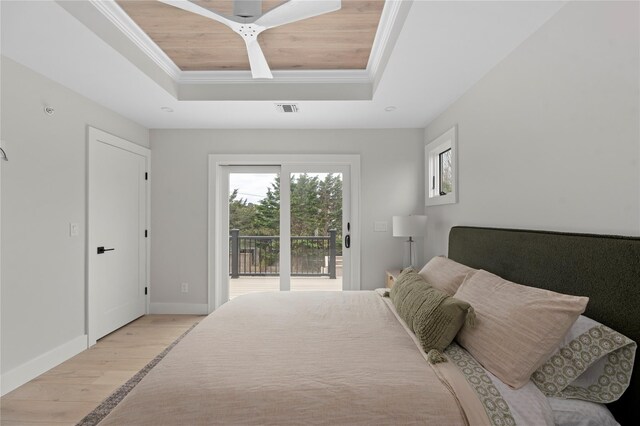 260 Wilmot Rd, Ocean Beach, NY 11770 - bedroom with light wood-style floors, access to exterior, baseboards, a tray ceiling, and ornamental molding