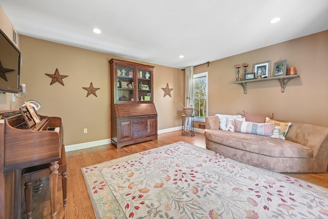 living room with recessed lighting, baseboards, and light wood finished floors