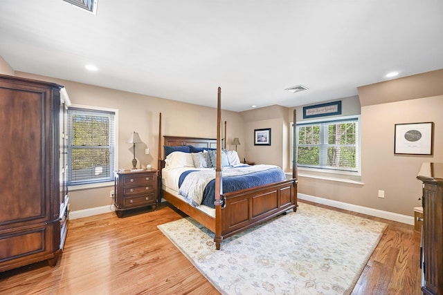bedroom featuring baseboards, visible vents, and light wood-type flooring