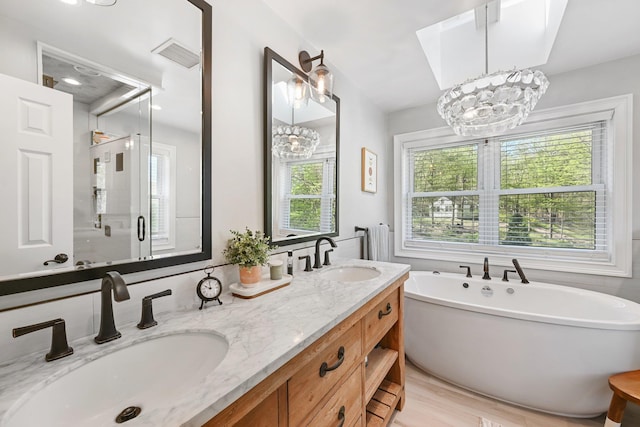 bathroom with visible vents, a sink, and a chandelier