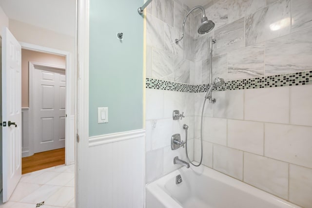 bathroom with wainscoting and shower / bathing tub combination