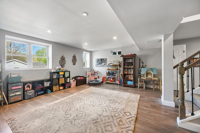 recreation room featuring recessed lighting, baseboards, and wood finished floors