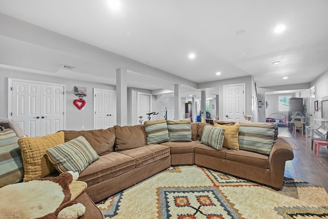 living room featuring recessed lighting, wood finished floors, and visible vents