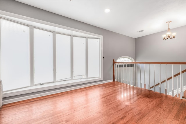 29 Fairway Dr, Rocky Point, NY 11778 - unfurnished room featuring recessed lighting, an inviting chandelier, wood finished floors, visible vents, and baseboards