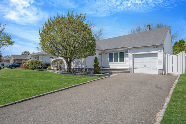 ranch-style home featuring a shingled roof, aphalt driveway, a front lawn, and an attached garage