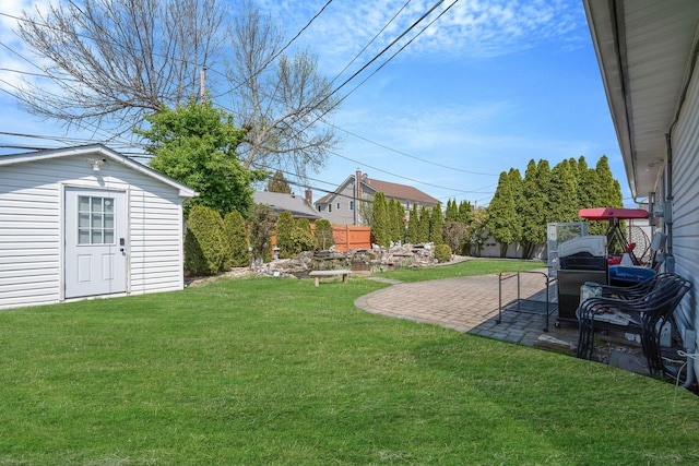 view of yard featuring a patio and an outbuilding