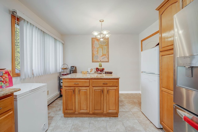 kitchen with light tile patterned floors, light countertops, freestanding refrigerator, and stainless steel fridge with ice dispenser