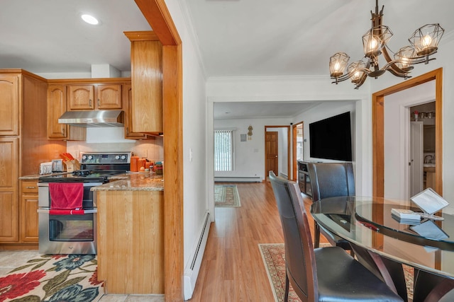 kitchen featuring light wood-style floors, under cabinet range hood, baseboard heating, range with two ovens, and a notable chandelier