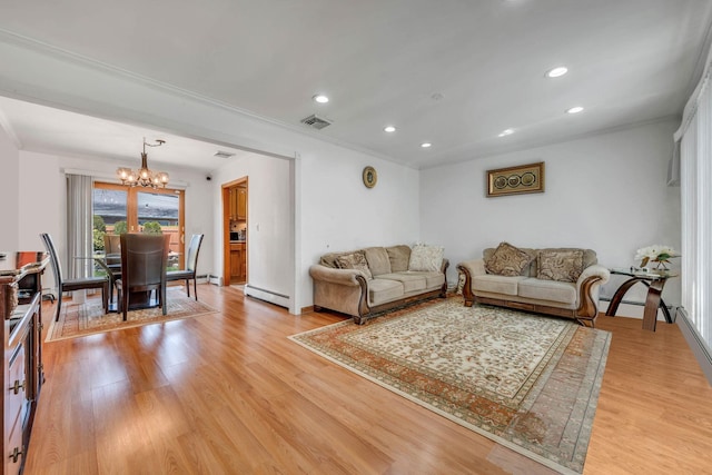 living room featuring crown molding, a baseboard radiator, visible vents, a chandelier, and light wood finished floors