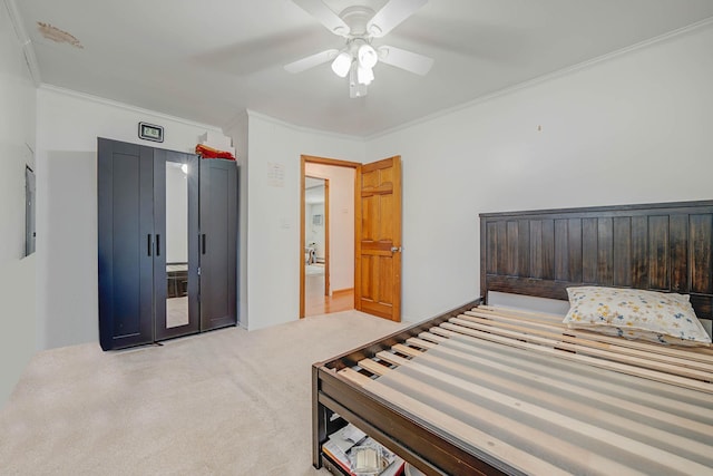 carpeted bedroom featuring ceiling fan and ornamental molding