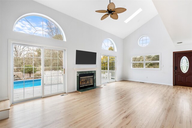 280 Shinnecock Hills Rd, Southampton, NY 11968 - unfurnished living room featuring a fireplace, high vaulted ceiling, a ceiling fan, light wood-type flooring, and visible vents