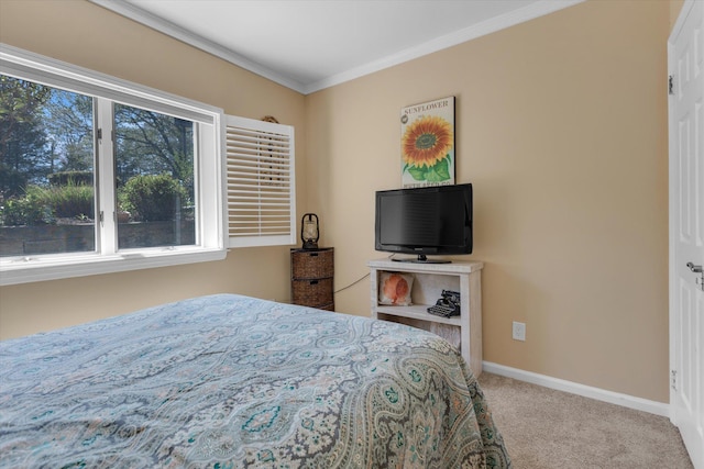 carpeted bedroom featuring baseboards and ornamental molding