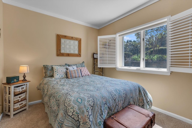 bedroom featuring baseboards, ornamental molding, and carpet flooring