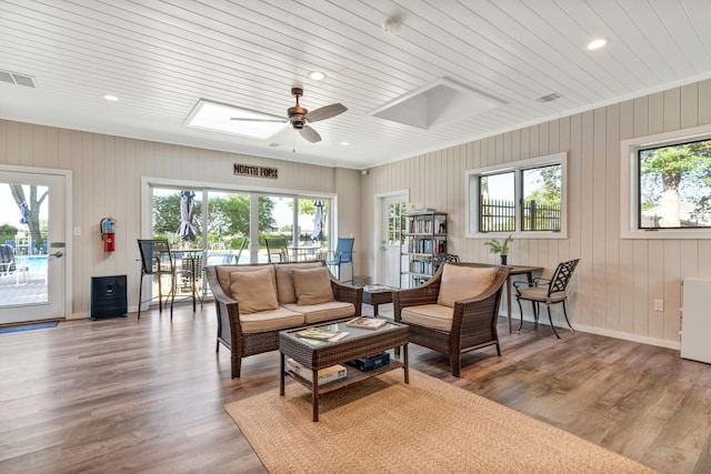 living room featuring a ceiling fan, baseboards, recessed lighting, wood finished floors, and visible vents