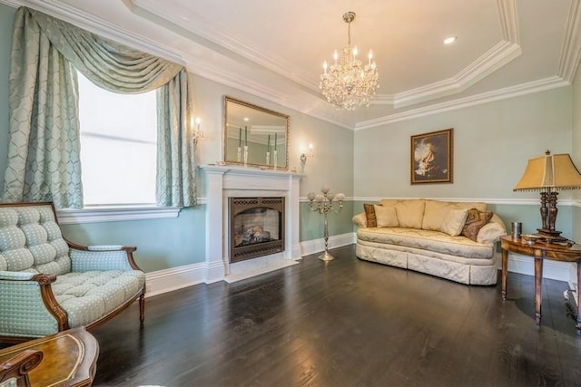 187 Lakeview Ave, Rockville Centre, NY 11570 - living area with a tray ceiling, wood finished floors, a chandelier, a fireplace with flush hearth, and crown molding