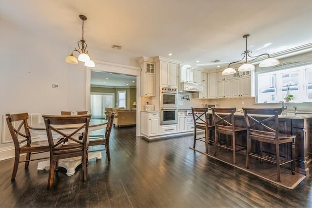 187 Lakeview Ave, Rockville Centre, NY 11570 - dining space featuring dark wood-type flooring, recessed lighting, a chandelier, and baseboards