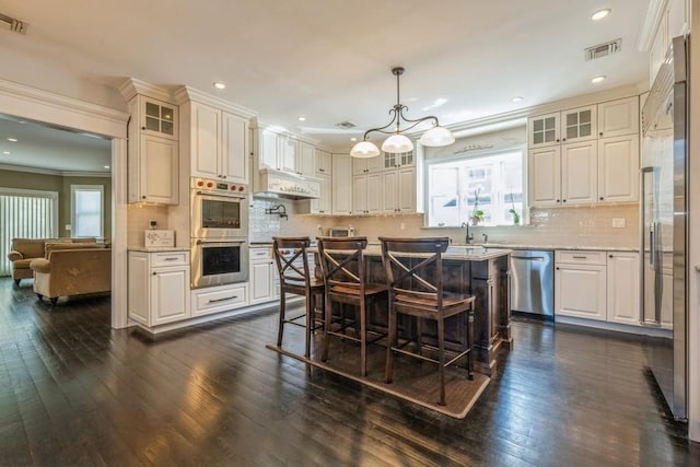 187 Lakeview Ave, Rockville Centre, NY 11570 - kitchen with appliances with stainless steel finishes, plenty of natural light, dark wood-style floors, recessed lighting, and ornamental molding