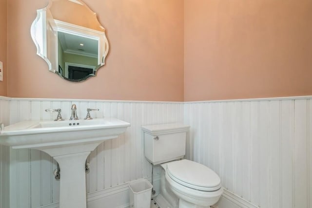 187 Lakeview Ave, Rockville Centre, NY 11570 - bathroom with a wainscoted wall, toilet, and a sink