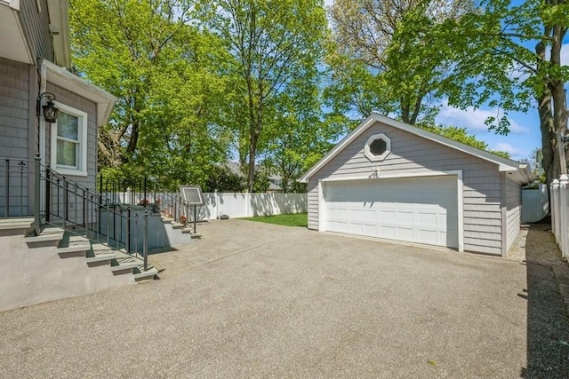 187 Lakeview Ave, Rockville Centre, NY 11570 - view of patio with a detached garage, an outbuilding, and fence