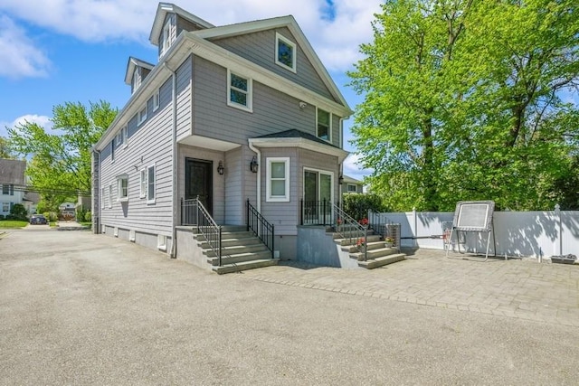 187 Lakeview Ave, Rockville Centre, NY 11570 - view of front of property featuring fence and a patio area