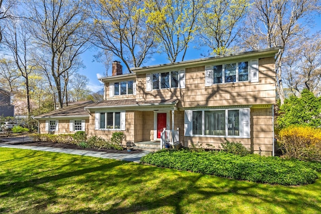 view of front of property with a front lawn and a chimney