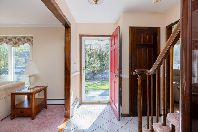 foyer featuring stairway, ornamental molding, and baseboard heating
