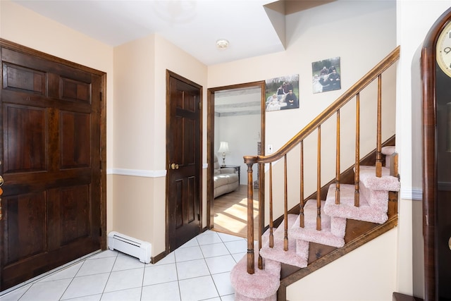 entrance foyer featuring stairs, light tile patterned flooring, and a baseboard radiator