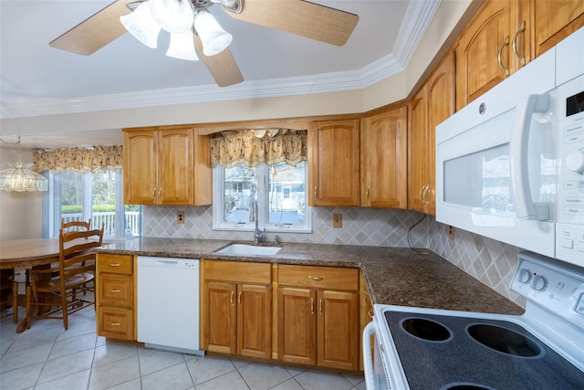 kitchen with ornamental molding, a sink, decorative backsplash, and white appliances