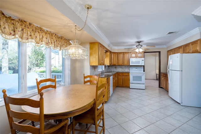 dining area featuring light tile patterned floors, visible vents, ornamental molding, and ceiling fan with notable chandelier