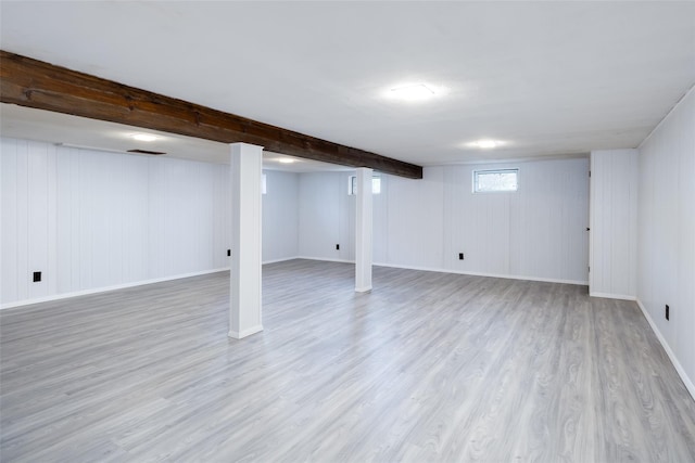 basement featuring wood finished floors and baseboards