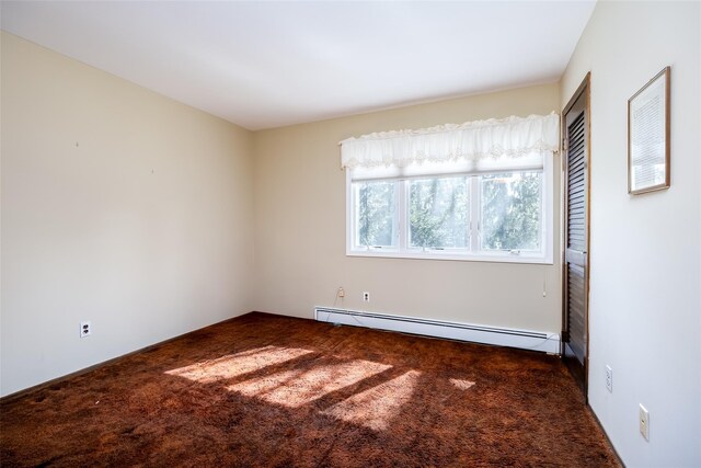 unfurnished room featuring baseboard heating and carpet floors