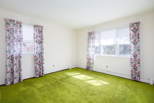 empty room with a baseboard heating unit, carpet floors, and plenty of natural light