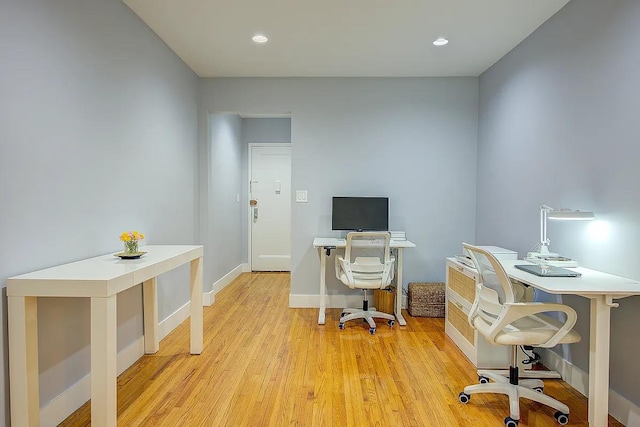 office space with recessed lighting, baseboards, and light wood-style flooring