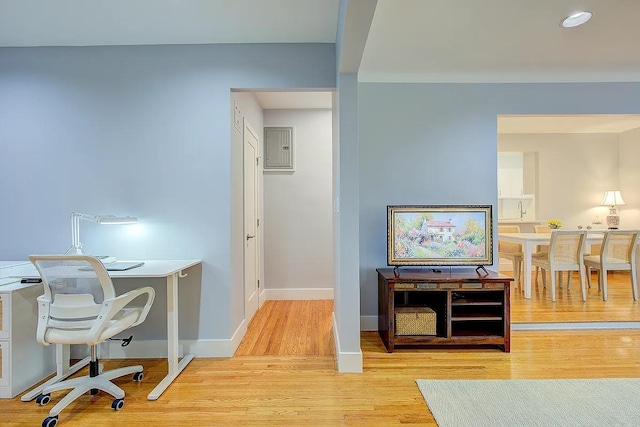 office space featuring recessed lighting, light wood-style flooring, and baseboards