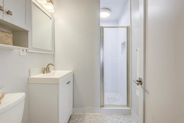 full bathroom with toilet, baseboards, tile patterned flooring, a shower stall, and vanity