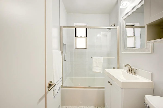 full bathroom with vanity, toilet, and bath / shower combo with glass door