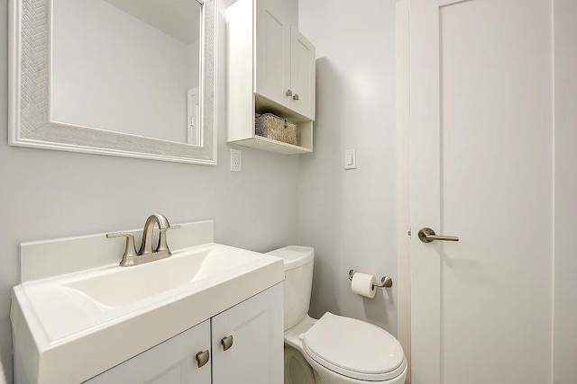 bathroom featuring toilet and vanity