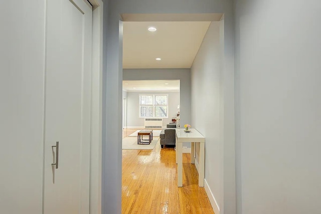 hallway with baseboards, recessed lighting, and light wood-type flooring