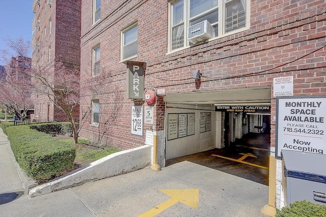 property entrance with brick siding and cooling unit