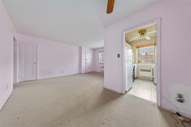 213-15 73rd Ave Lower, Lower, Oakland Gardens, NY 11364 - empty room with a ceiling fan, light colored carpet, and radiator