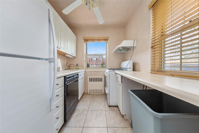 213-15 73rd Ave Lower, Lower, Oakland Gardens, NY 11364 - kitchen with light tile patterned flooring, white appliances, radiator heating unit, under cabinet range hood, and white cabinets
