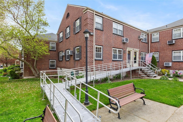213-15 73rd Ave Lower, Lower, Oakland Gardens, NY 11364 - rear view of house featuring a lawn, a wall mounted air conditioner, and brick siding
