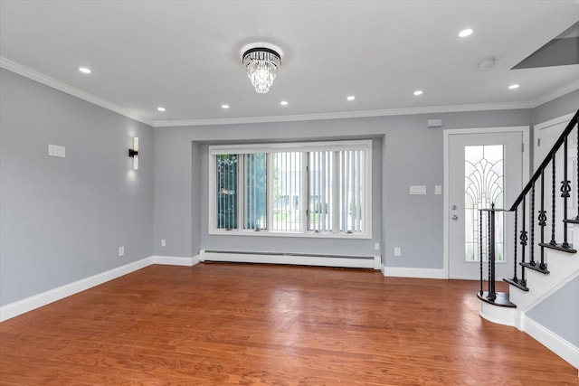 foyer featuring a baseboard radiator, baseboards, ornamental molding, wood finished floors, and stairs