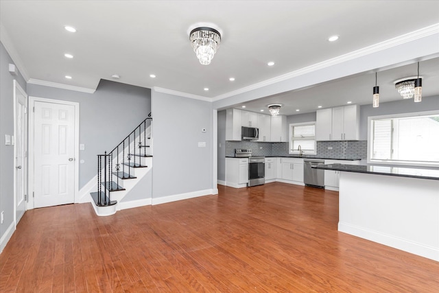 kitchen with dark countertops, tasteful backsplash, stainless steel appliances, and baseboards
