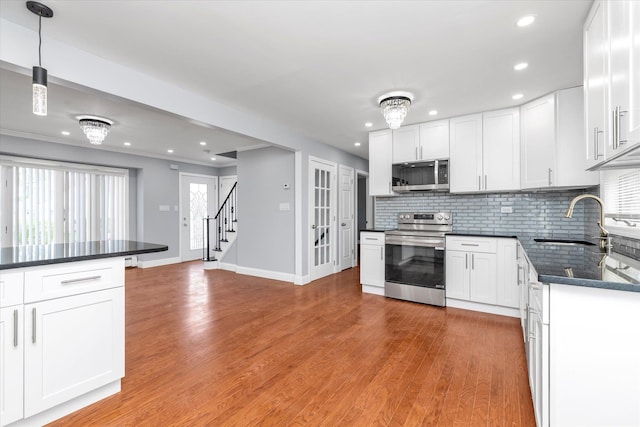 kitchen with stainless steel appliances, recessed lighting, and a sink