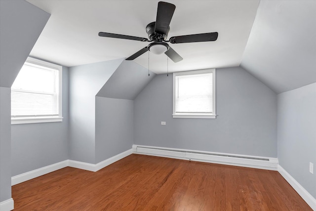 bonus room with ceiling fan, wood finished floors, baseboards, baseboard heating, and lofted ceiling