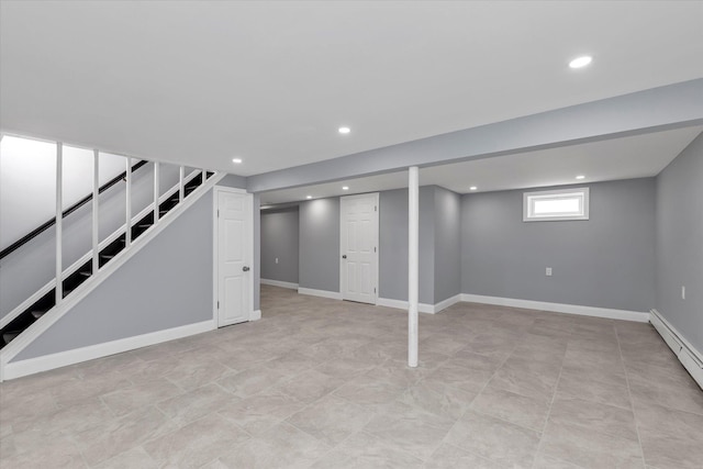 basement featuring a baseboard heating unit, recessed lighting, stairway, and baseboards
