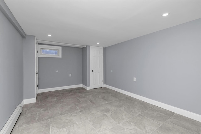 below grade area featuring a baseboard heating unit, recessed lighting, and baseboards