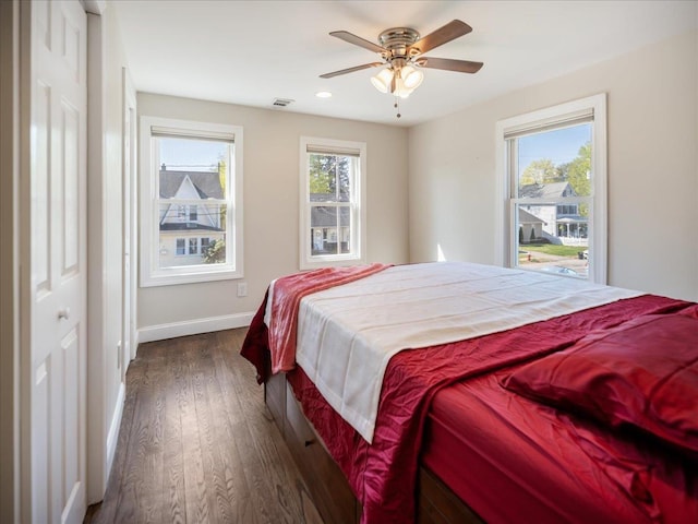 bedroom featuring recessed lighting, ceiling fan, visible vents, baseboards, and dark wood finished floors