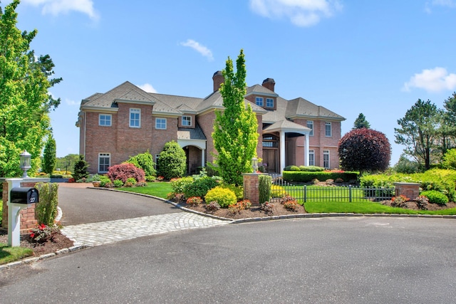 27 True Harbour Way W, Islip, NY 11795 - view of front of property with brick siding, a chimney, and driveway